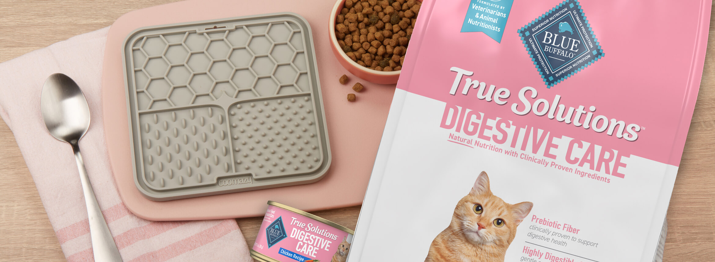 Blue Buffalo Digestive Care cat food packaging with feeding mat and kibble bowl